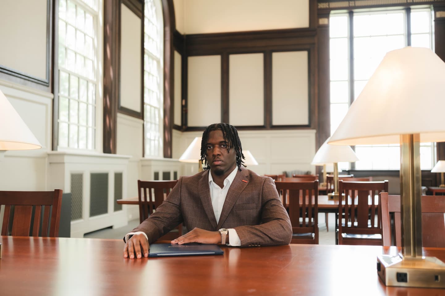 UConn student graduate in South Reading Room at Wilbur Cross