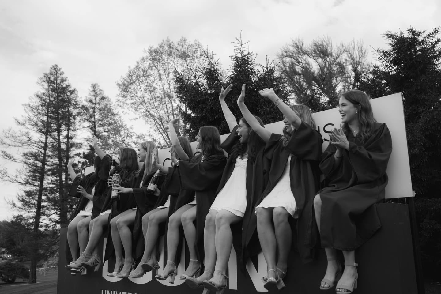 UConn student graduates waving